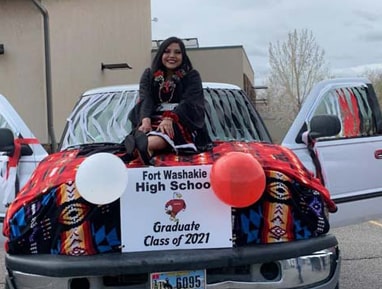 High School student with car and Class of 2021 sign