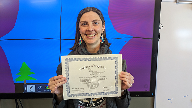 Mrs. Clarke holding certificate