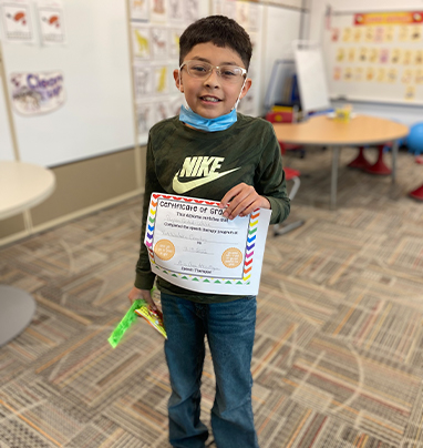 student holding a certificate