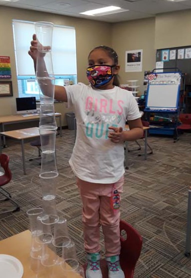 student stacking cups