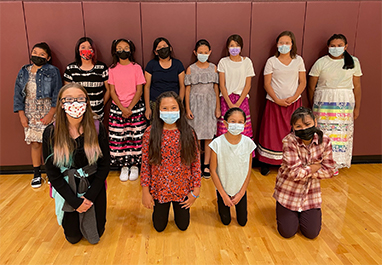 group of girls in masks in the gym