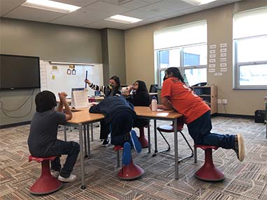 Students working as group at desk