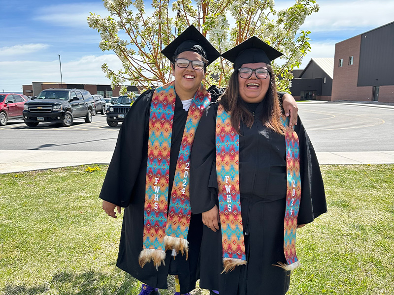 Two happy SPED students outside during graduation